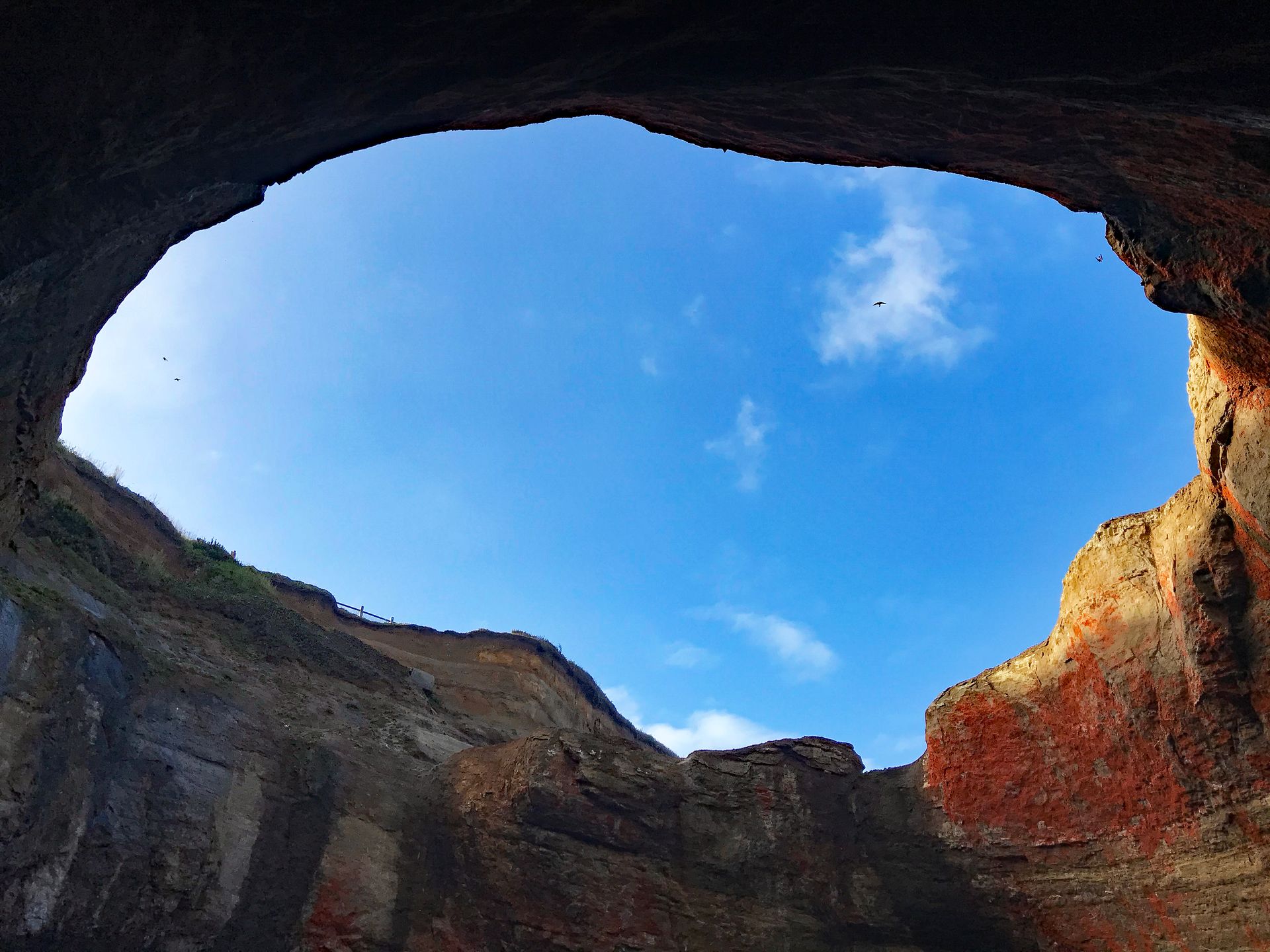 Looking towards the rim of Devil's Punch Bowl.  High above is the railing from where you usually look down into this bowl of crashing waves.